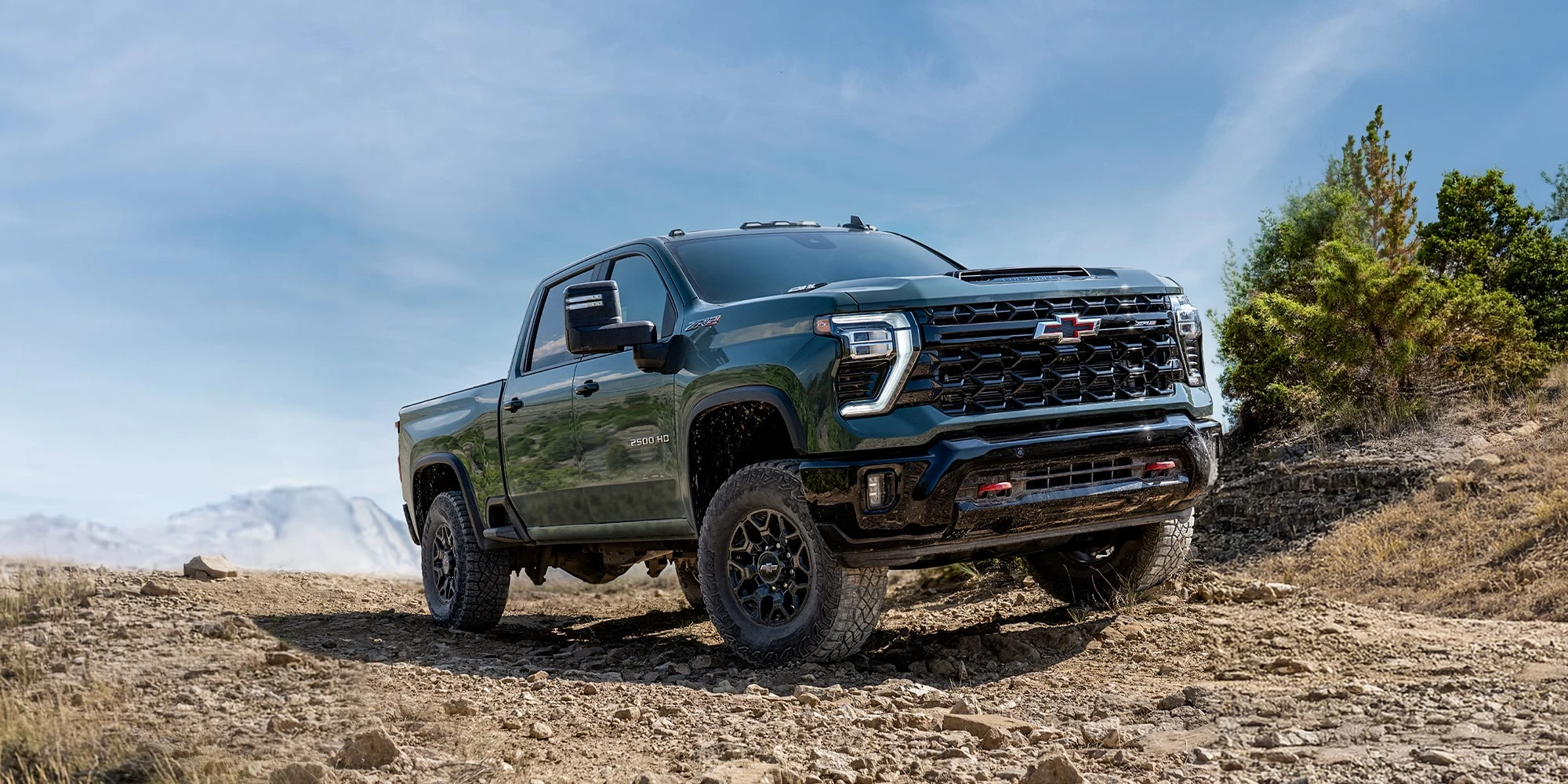 Black Chevrolet Silverado HD crossing rocky ground