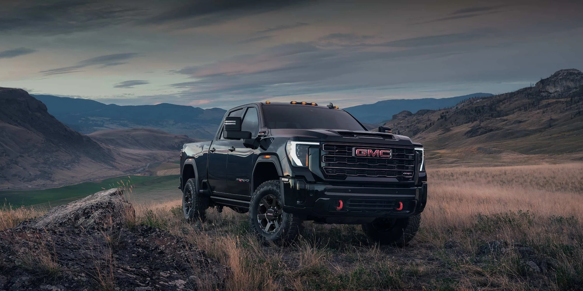 Dark GMC Sierra HD AT4X parked on a hill