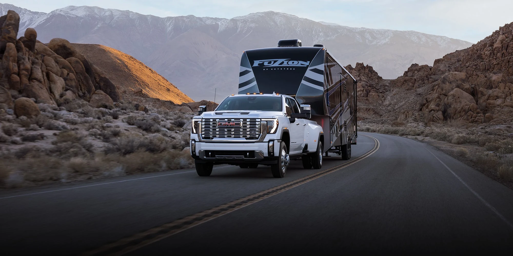 White GMC Sierra HD dually towing a fifth-wheel trailer